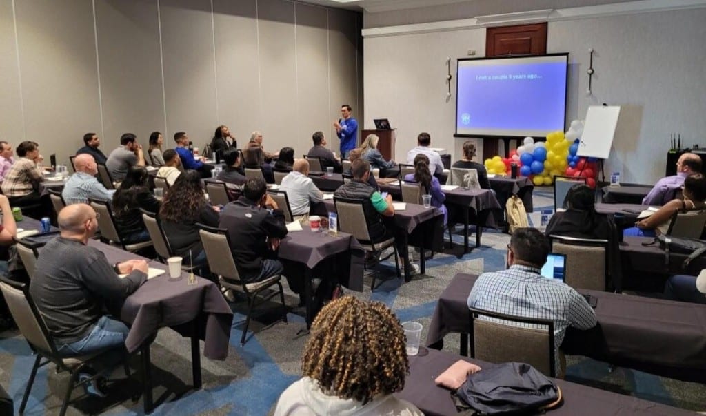 Sam Kwak presenting the Accelerated Payoff strategy to a full room