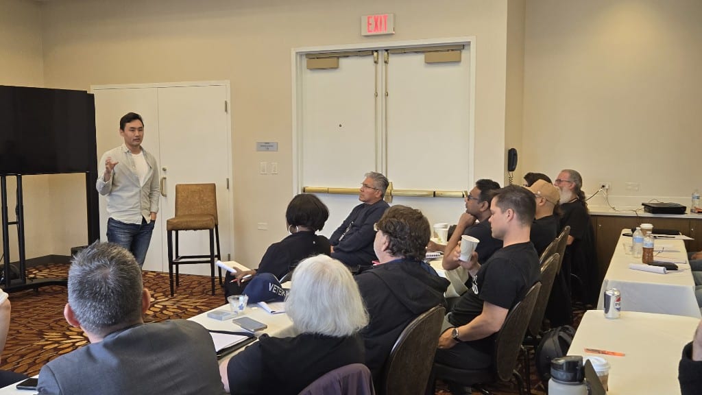 Sam Kwak answering questions in a small-group session